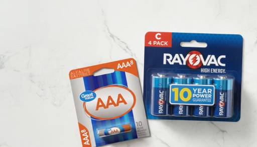 An eight pack of Great Value AAA batteries and a four pack of Rayovac C batteries against a marble background.