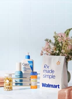 CeraVe body lotion, e.l.f. face moisturizer, prescription bottle, Ritual multivitamins, and a "Rx made simple" bag on a bathroom counter.